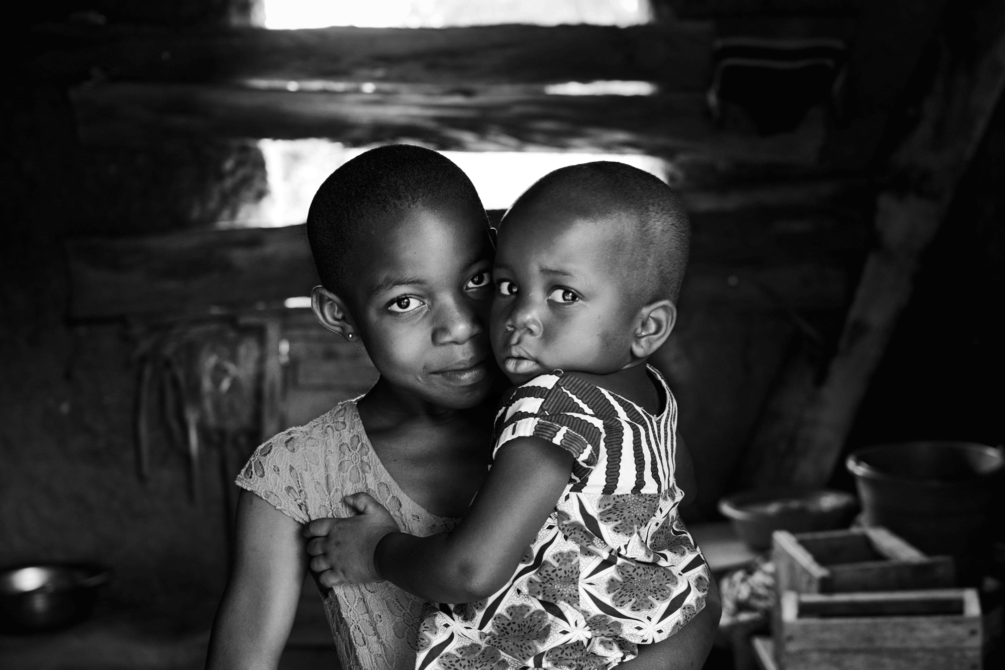 Looking after little sister is easier with a library, clean water and toilets that Community Action Ghana provided in Abunyanyana.